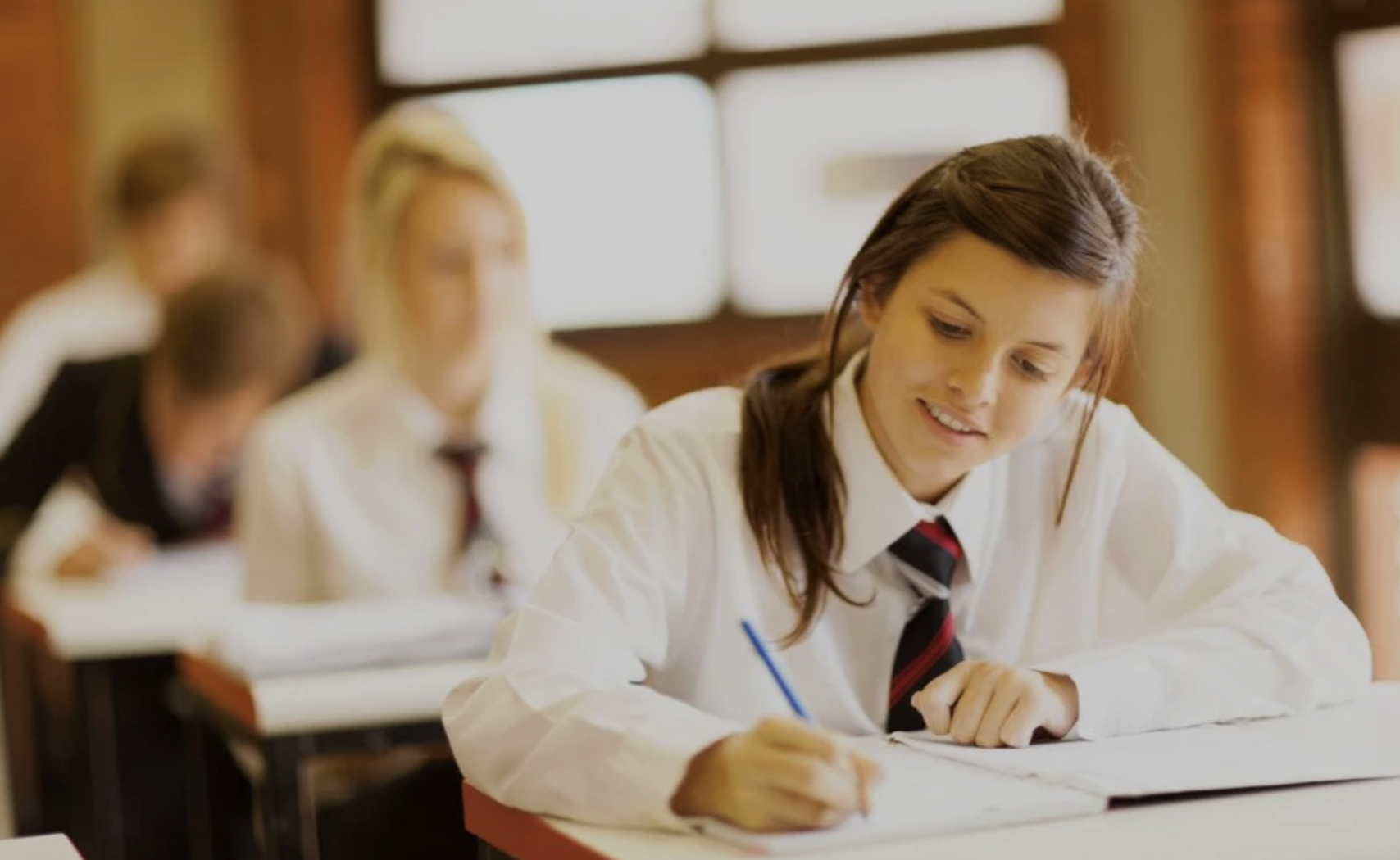 Student writing confidently
